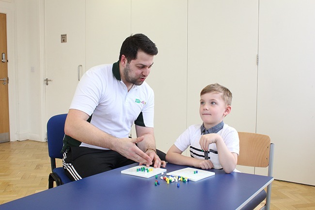 Child looking up not paying attention to the task