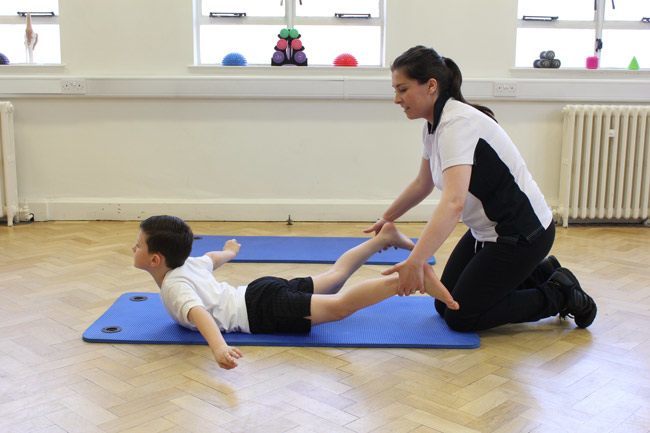 Small boy laid on his belling spreading his arms and legs out in a star shape